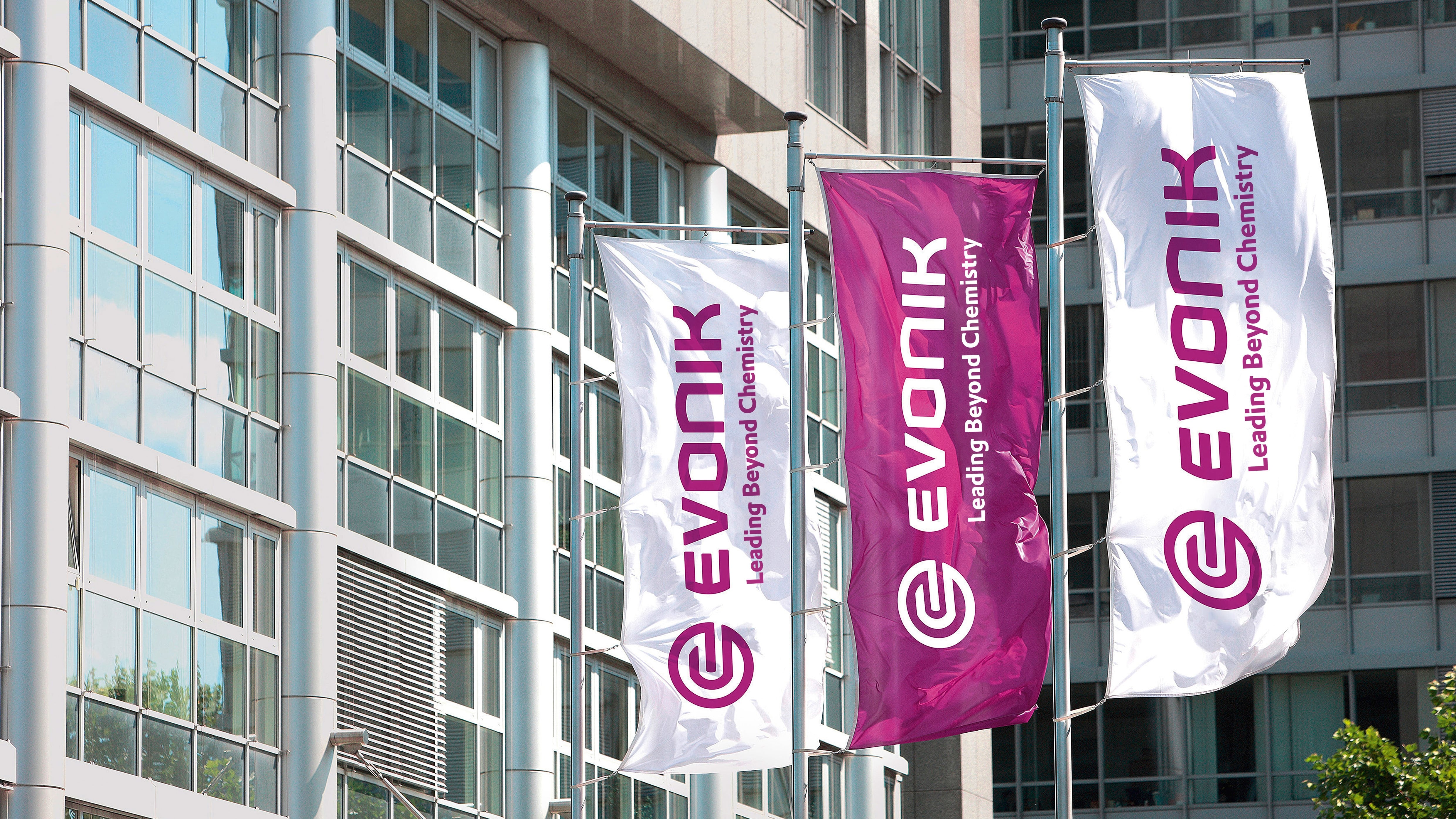 Three flags fluttering outside an office building