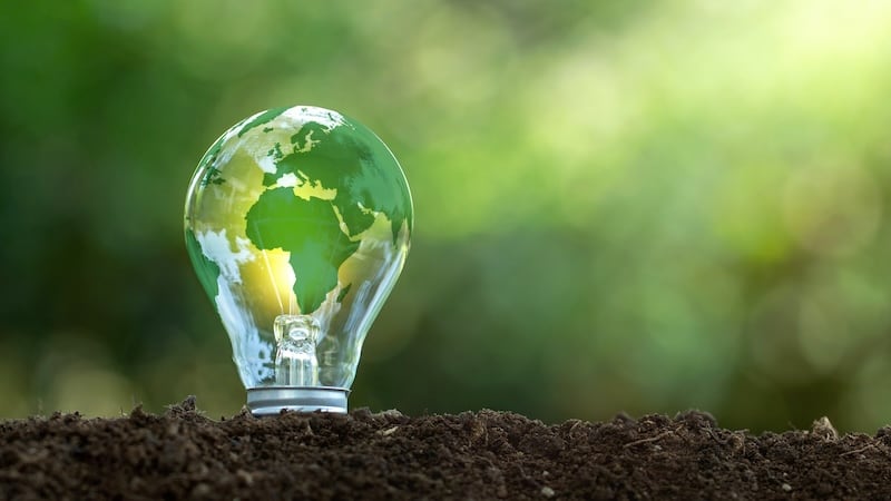 a lightbulb with a globe design on a green background