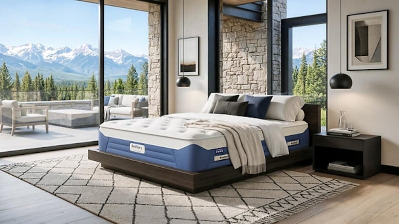 a mattress on a bed next to patio windows with snowy mountains in the distance