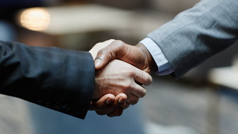 A handshake between two men in suits