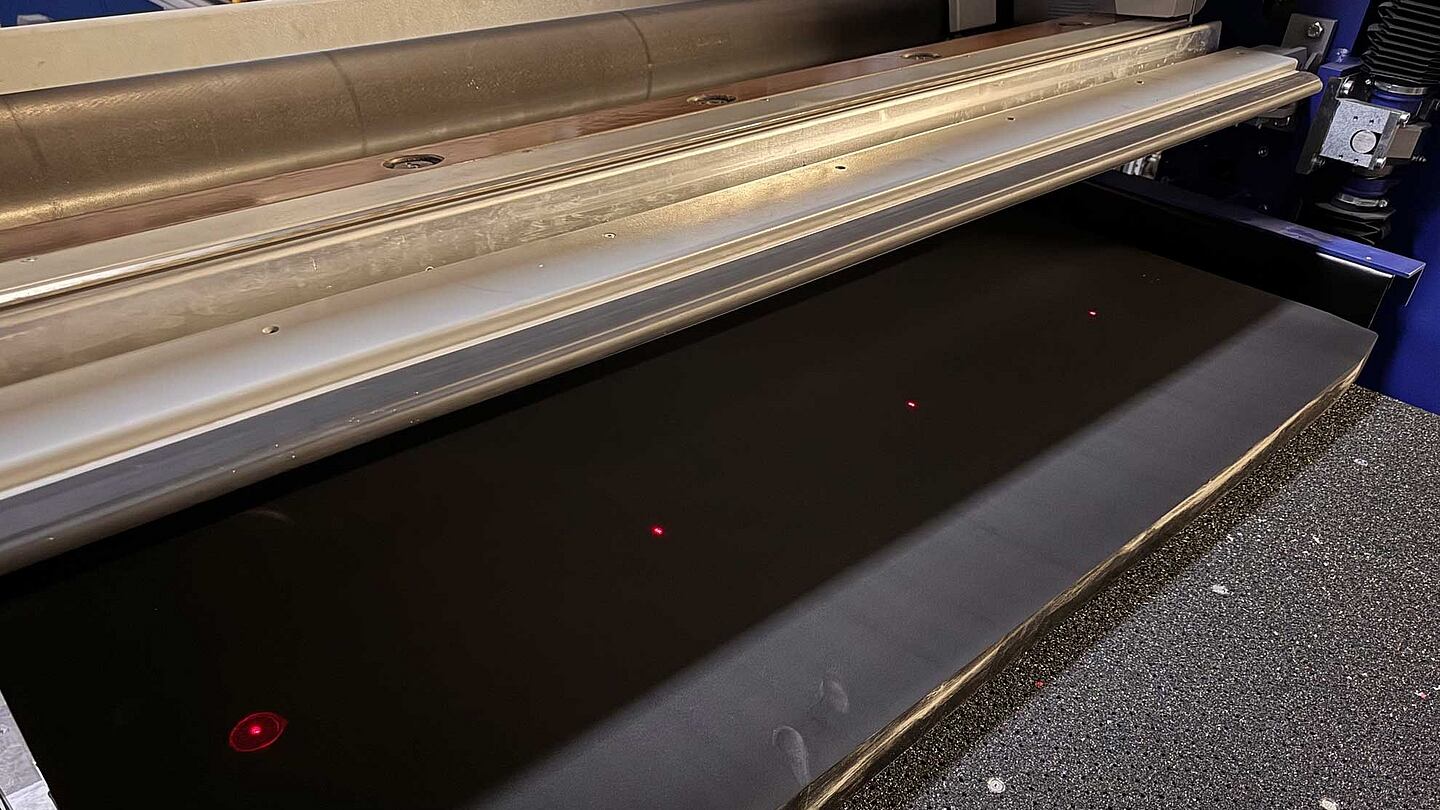 four red laser lights on a machine